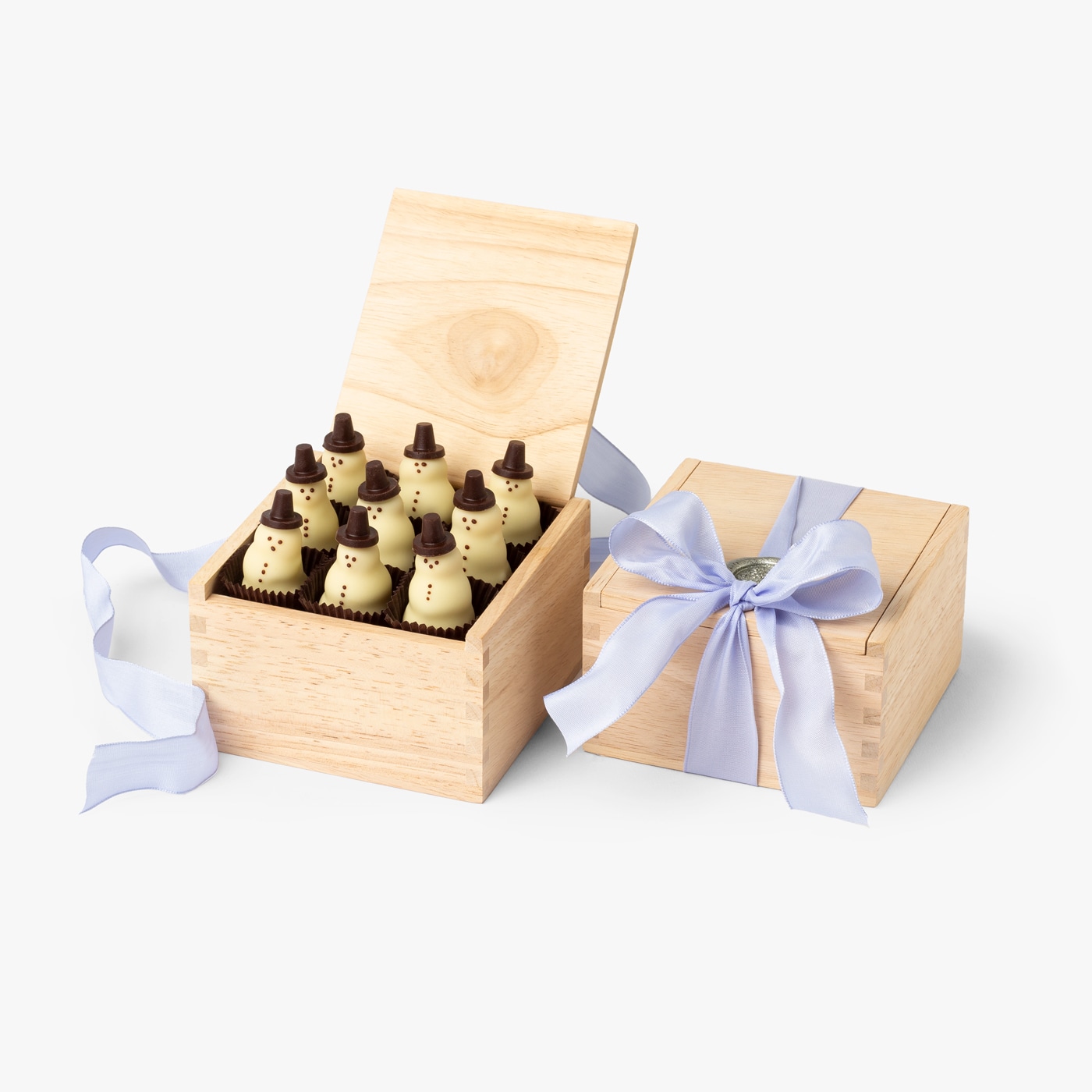 Handcrafted chocolate snowmen packaged inside Burdick's signature wooden box and finished with a satin bow.
